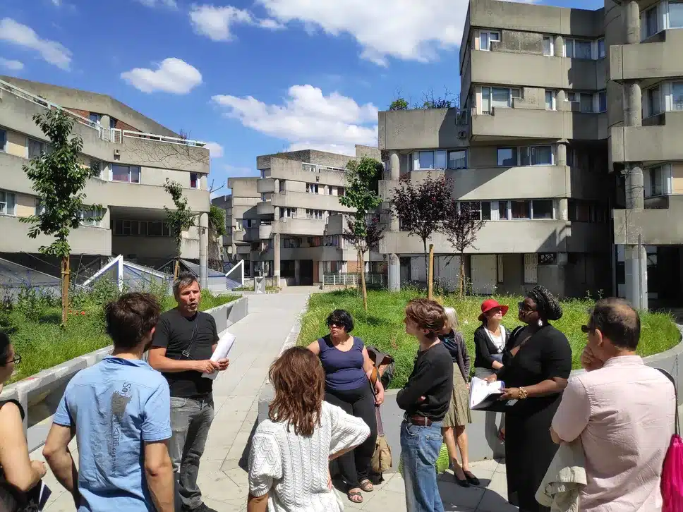 Public d'une balade urbaine autour d'un guide dans un quartier d'habitation
